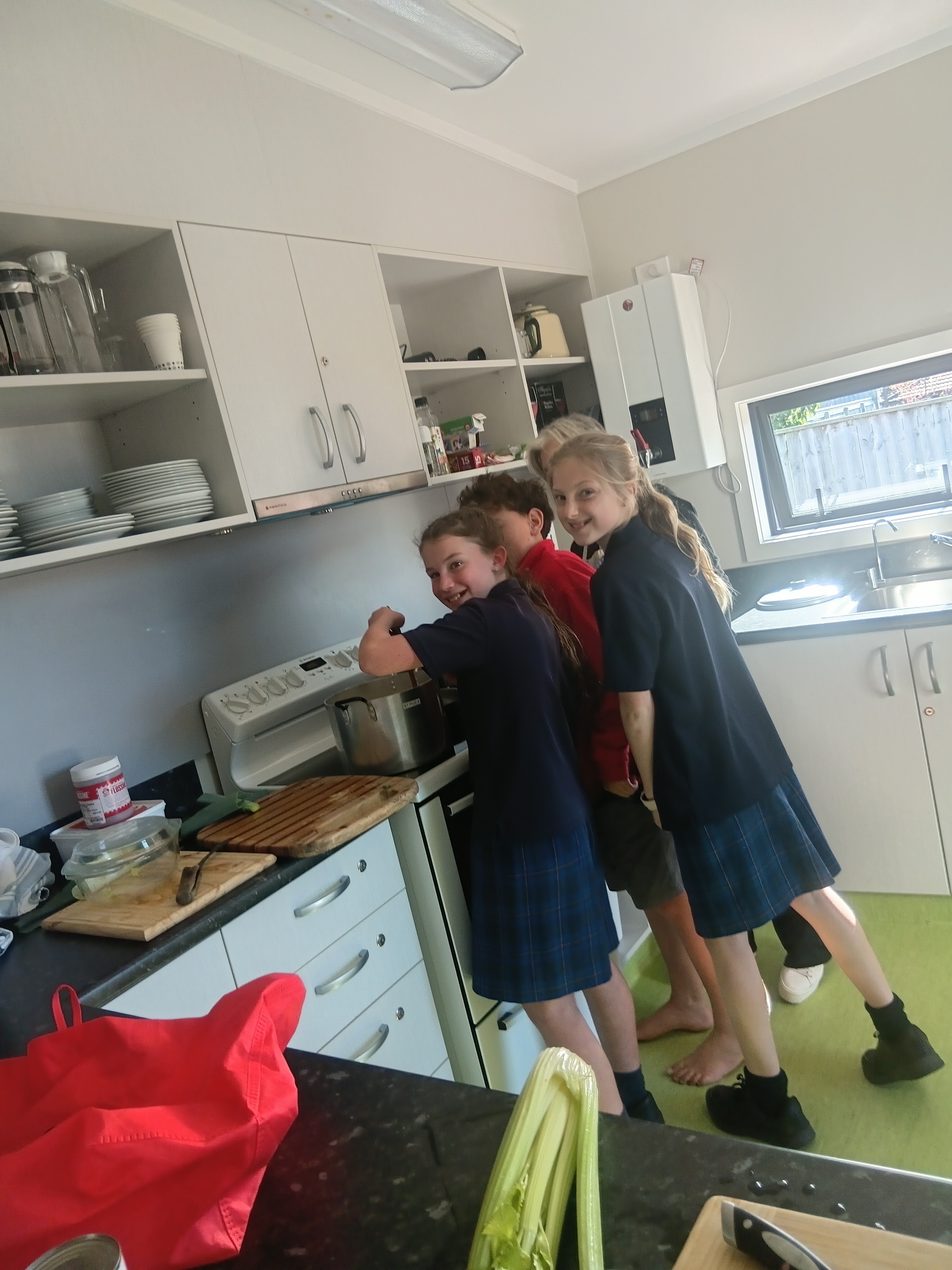 Young Vinnies stirring soup for the Tuesday community meal